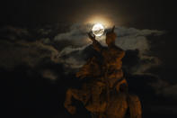 The supermoon rises near the equestrian statue of Damdin Sukhbaatar on Sukhbaatar Square in Ulaanbaatar, Mongolia, on Wednesday, Aug. 30, 2023. August 30 sees the month's second supermoon, when a full moon appears a little bigger and brighter thanks to its slightly closer position to Earth. (AP Photo/Ng Han Guan)