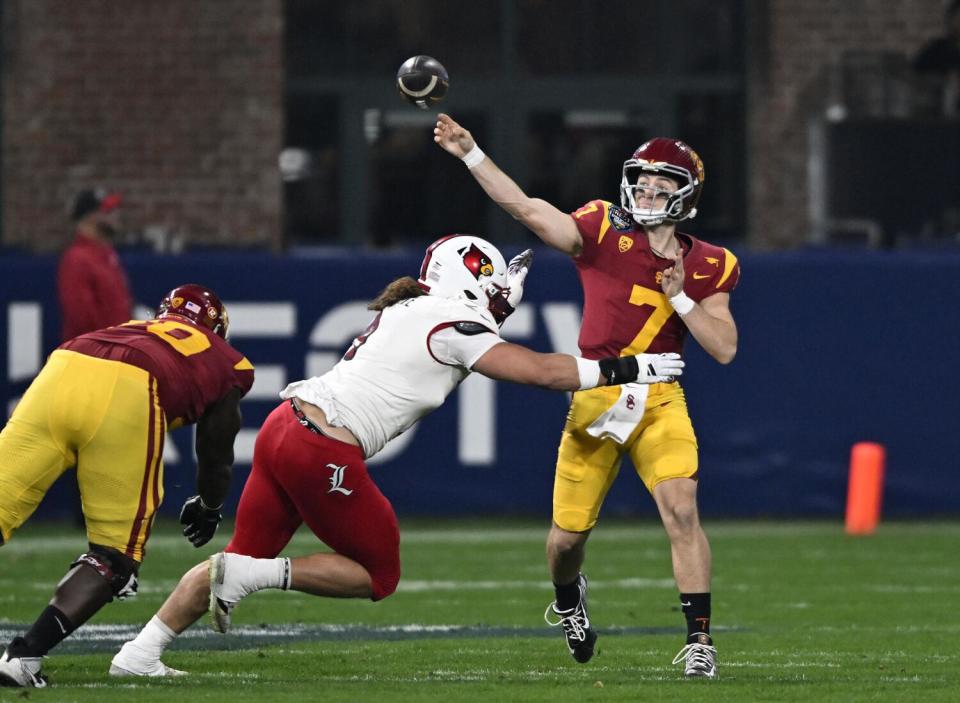 Miller Moss throws a pass under pressure.