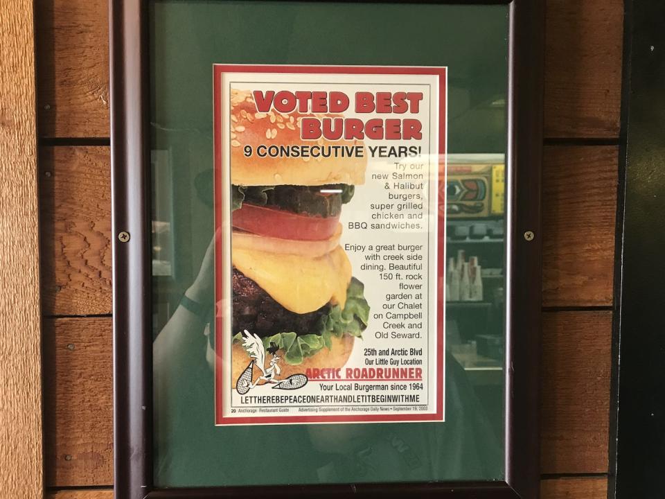 Green, red, and white sign that says Arctic Roadrunner was voted best burger