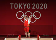 <p>China's Wenwen Li celebrates gold with a heart following the Women's +87kg Group A Weightlifting at Tokyo international Forum on August 2.</p>