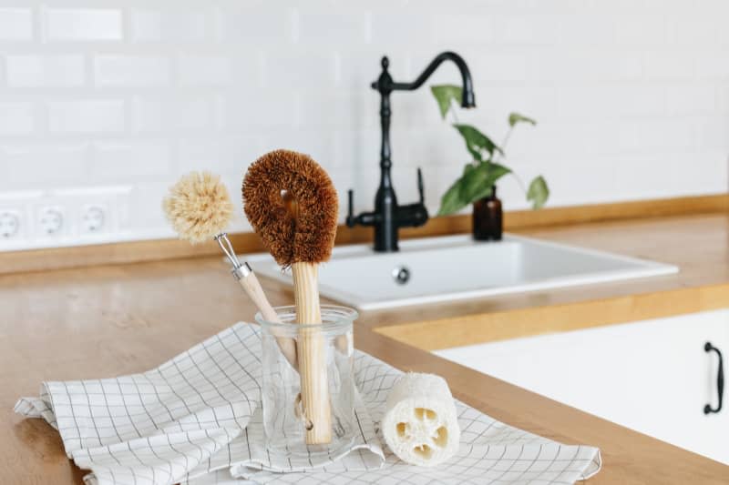 Plant Based Cleaning Brush Set Kitchen white kitchen background. Eco friendly kitchen, zero waste home concept