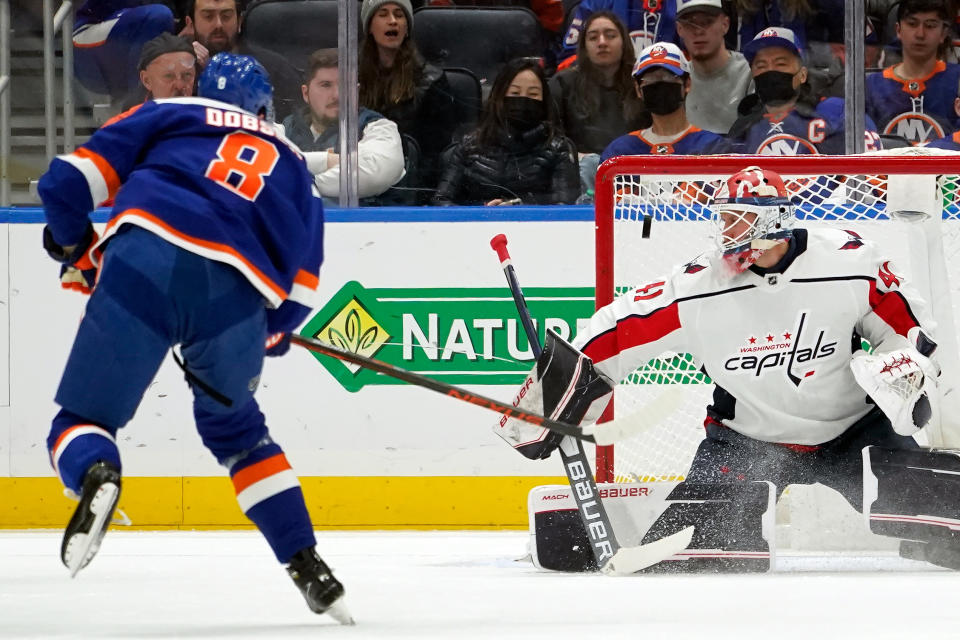 Washington Capitals goaltender Vitek Vanecek (41) makes a save against New York Islanders defenseman Noah Dobson (8) during the first period of an NHL hockey game, Saturday, Jan. 15, 2022, in Elmont, N.Y. (AP Photo/Mary Altaffer)