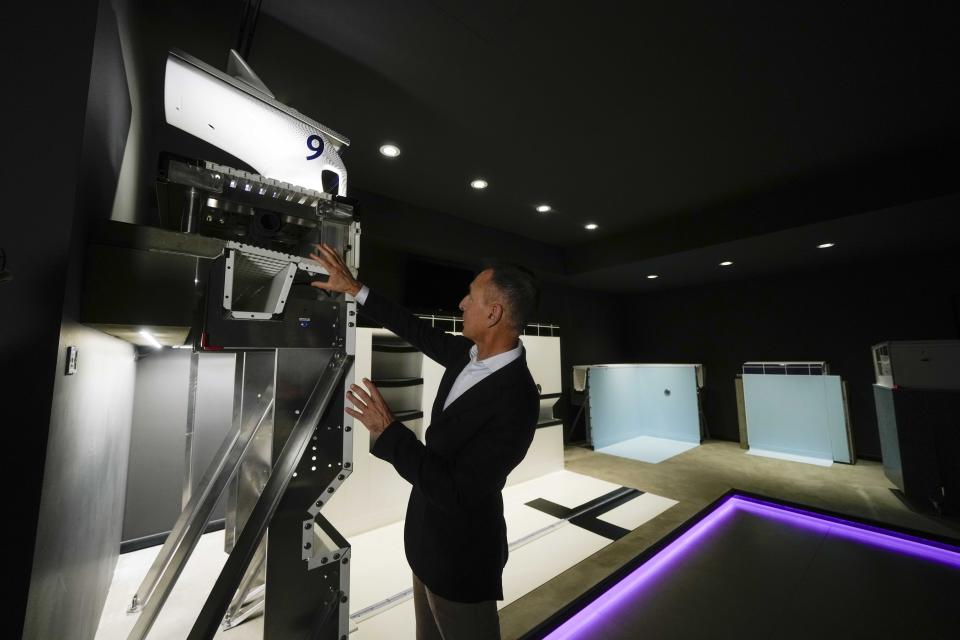 Roberto Colletto, CEO of Myrtha Pools gestures as he explains the section of the Paris Olympic pool, at the Myrtha Pools factory, in Castiglione delle Stiviere, northern Italy, Tuesday, March 12, 2024. Italian company Myrtha Pools is producing 24 pools for the Paris Olympics at its factory in Castiglione delle Stiviere, near Verona. The pools will be used for swimming, diving, water polo, artistic swimming and training areas in Paris. It's the sixth Olympics that Myrtha will be providing pools for. (AP Photo/Luca Bruno)