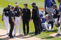 Chicago White Sox's Jose Abreu, left, heads to the dugout as Kansas City Royals' Hunter Dozier tries to get up after they collided along the first base line in the second inning of the first game of a baseball doubleheader Friday, May 14, 2021, in Chicago. (AP Photo/Charles Rex Arbogast)