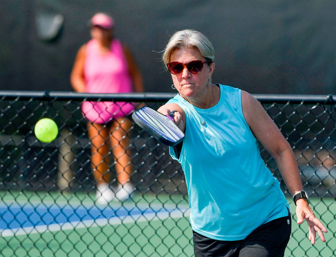 Laurie Dell returns a shot while playing pickleball at the Tattnall Square Pickleball Center. Jason Vorhees/The Telegraph