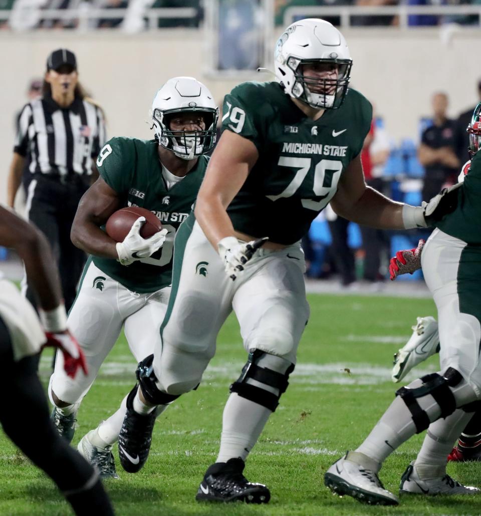 Michigan State Spartans offensive tackle Jarrett Horst (79) blocks for running back Kenneth Walker III (9) during action against the Western Kentucky Hilltoppers Saturday, Oct. 02, 2021.