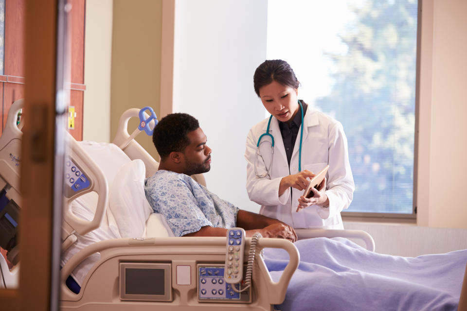 Doctor showing a patient their chart.