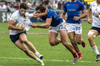 France's Pierre Mignot tackles Uruguay's Mateo Vinals during the second day of the Hong Kong Sevens rugby tournament in Hong Kong, Saturday Nov. 5, 2022. The Hong Kong Sevens, a popular stop on the World Rugby Sevens Series circuit, is part of the government's drive to restore the city's image as a vibrant financial hub after it scrapped mandatory hotel quarantine for travelers.(AP Photo/Vernon Yuen)