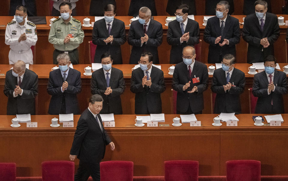 Image: Chinese president Xi Jinping is applauded by delegates wearing protective masks as he arrives at the opening of the National People's Congress (Kevin Frayer / Getty Images)