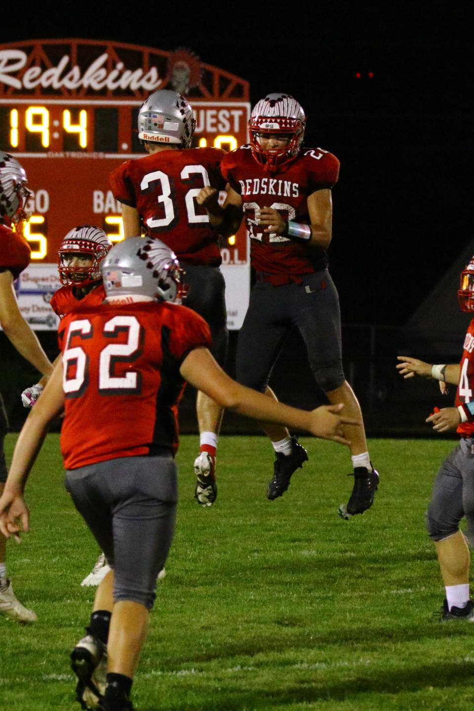 Utica junior Tyler Collura (32) and sophomore Hayden Piper (22) celebrate a hard-earned win against visiting Centerburg in the season opener on Friday, Aug. 19, 2022. Utica scored late to edge the Trojans 26-19.