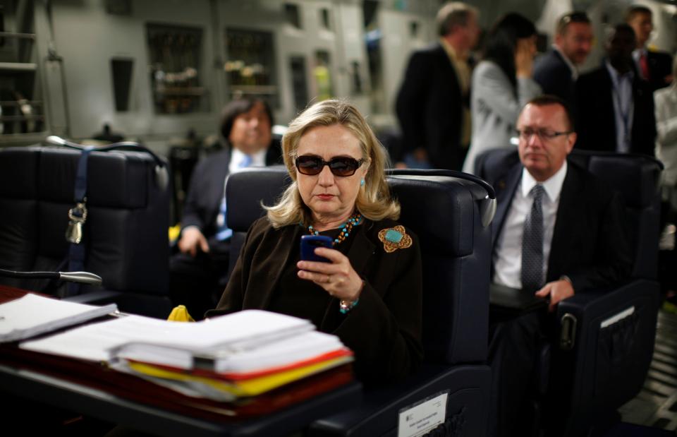 Secretary of State Hillary Rodham Clinton checks her Blackberry from a desk inside a C-17 military plane upon her departure from Malta and en route to Tripoli, Libya, on Oct. 18, 2011.