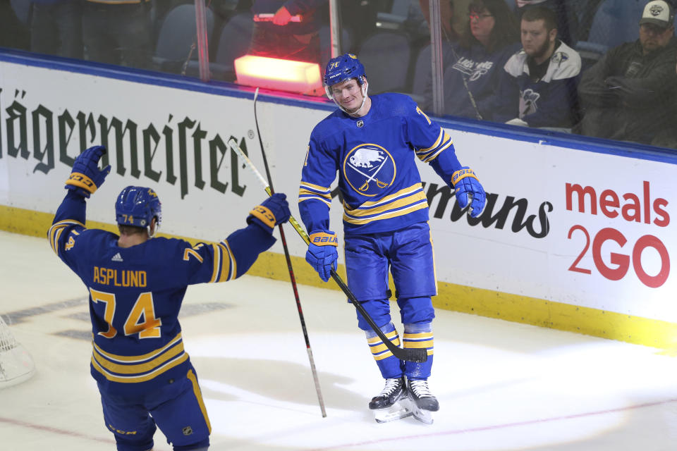 Buffalo Sabres right wing Rasmus Asplund (74) and right wing Victor Olofsson (71) celebrate after Olofsson scored an empty-net goal during the third period of an NHL hockey game against the Tampa Bay Lightning on Monday, Oct. 25, 2021, in Buffalo, N.Y. (AP Photo/Joshua Bessex)