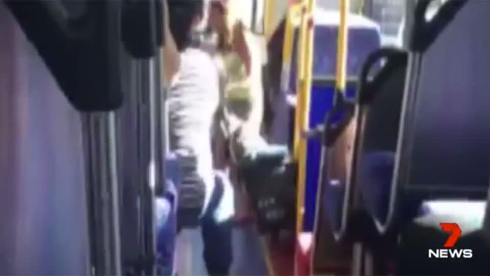 The woman can be seen on the footage storming off the packed bus. Source: 7 News.