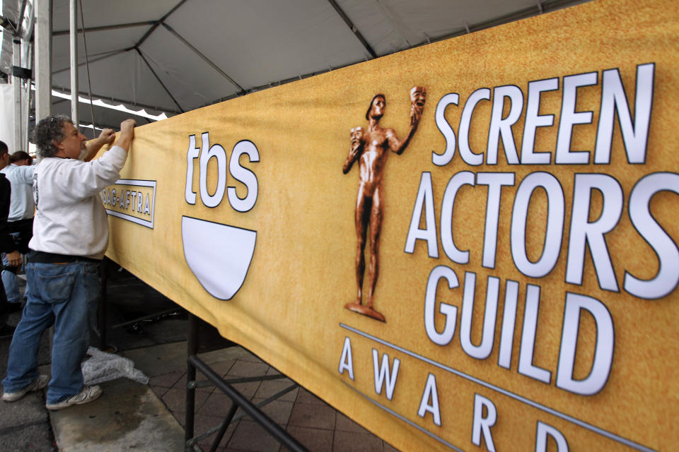 Workers set up signage on the red carpet before the 19th annual SAG Awards on Saturday, Jan 26, 2013 in Los Angeles. The SAG Awards will be held Jan. 27, 2013. (Photo by Matt Sayles/Invision/AP)