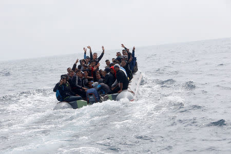 Migrants are seen before disembarking from a dinghy at Del Canuelo beach as they cross the Strait of Gibraltar sailing from the coast of Morocco, in Tarifa, southern Spain, July 27, 2018. REUTERS/Stringer