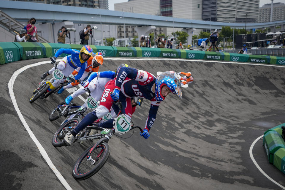 FILE - Connor Fields, of the United States, center, who later crashed, is followed by Romain Mahieu of France, center-left, and Vincent Pelluard of Colombia, left, as they compete in the men's BMX Racing semifinals at the 2020 Summer Olympics, Friday, July 30, 2021, in Tokyo, Japan. The American was racing into the first corner in a semifinal when he clashed wheels with a French rider, sending him down. Two more riders fell on him. Fields briefly tried to sit up, then lost consciousness, and would not wake again for three days. (AP Photo/Ben Curtis, File)