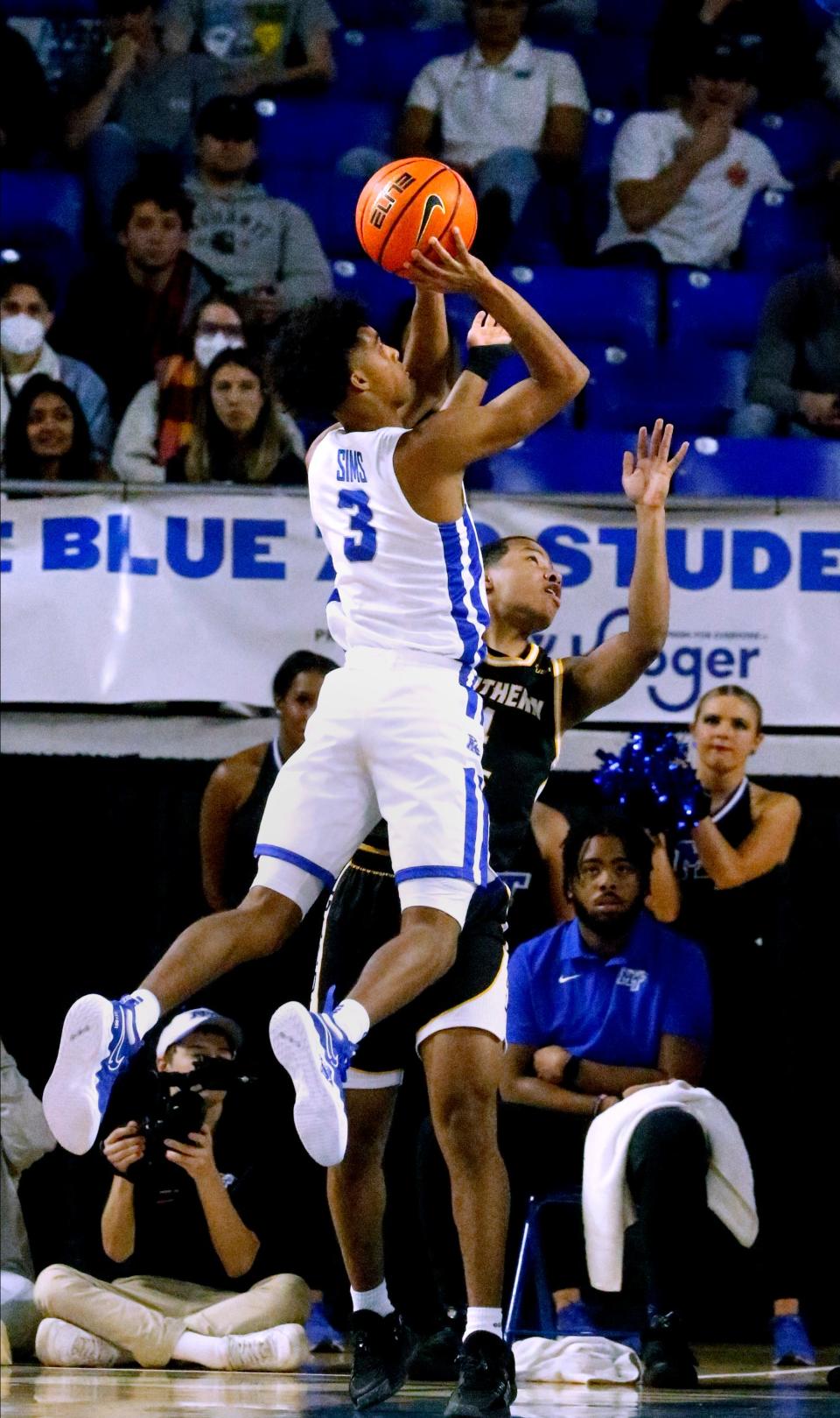 MTSU guard Donovan Sims (3) shoots the ball as Southern Miss guard Rashad Bolden (4) guards him on Saturday, Jan. 22, 2022, at MTSU's Monte Hale Arena in Murphy Center in Murfreesboro, Tenn.