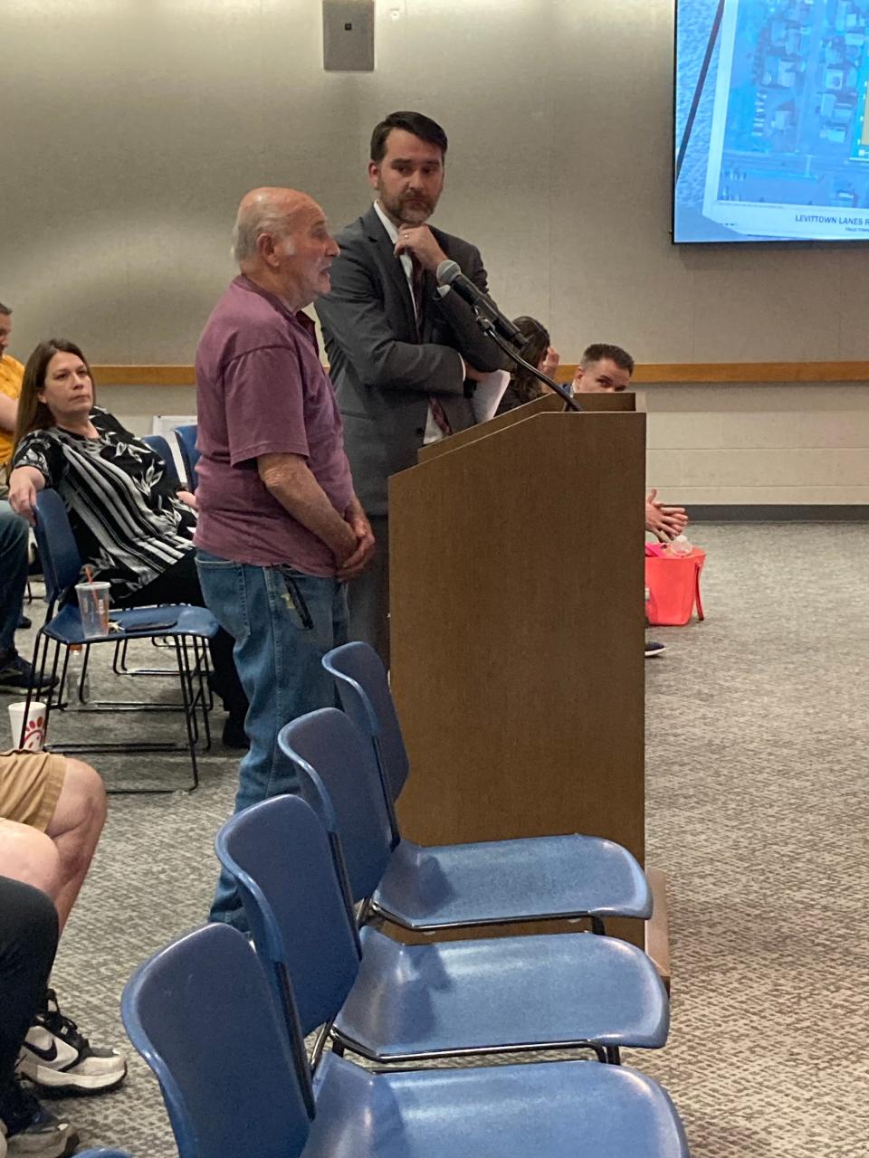 Al Episcopo, owner of the Levttown Lanes bowling alley property in Falls, and his lawyer, Michael Meginniss, makes the case for redeveloping the land for 24 apartments along New Falls Road at the township zoning board hearing on April 9, 2024.