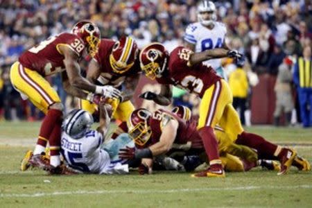 Dallas Cowboys wide receiver Devin Street (15) fumbles the ball against the Washington Redskins in the third quarter at FedEx Field. The Cowboys won 19-16. Mandatory Credit: Geoff Burke-USA TODAY Sports