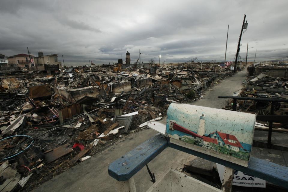 A mailbox with a lighthouse design sits on the porch of a burned out home in the Breezy Point section of New York's Queens borough on Tuesday, Nov. 13, 2012. More than 50 homes were lost in a fire that swept through the oceanside community during Superstorm Sandy. (AP Photo/Mark Lennihan)