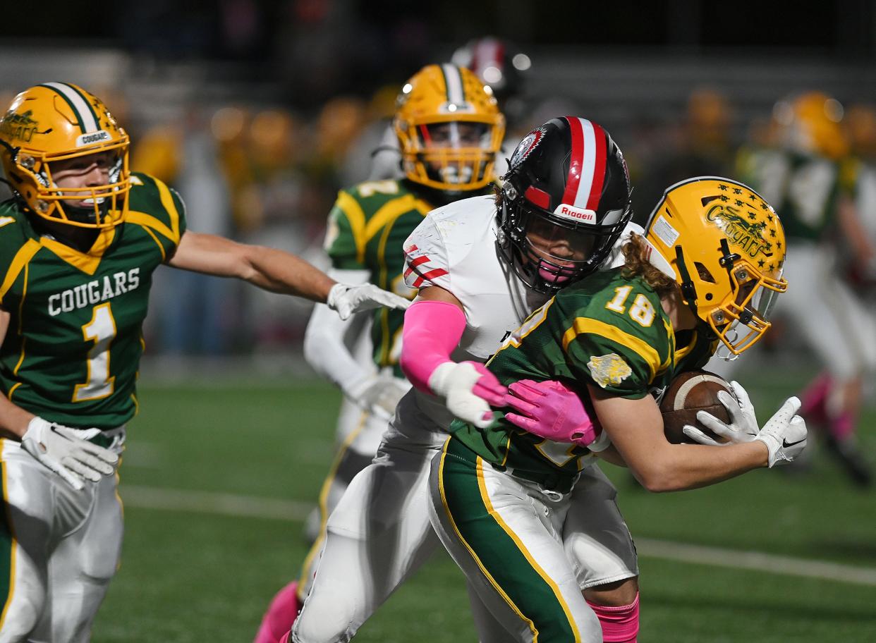 Aliquippa's Cameron Lindsey tackles Blackhawk's Connor McGraw (18) during Friday night's game at Blackhawk High School.