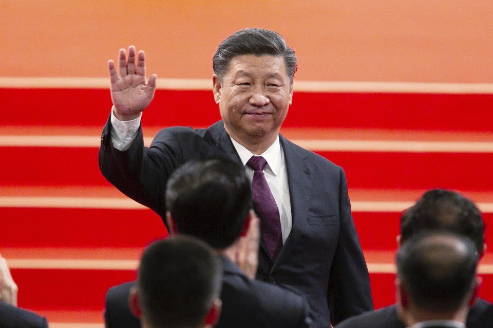 FILE - In this Dec. 20, 2019, file photo, Chinese President Xi Jinping waves during the inauguration ceremony in Macao to mark the 20th anniversary of the former Portuguese colony's handover to Chinese rule. China, Thursday, Sept. 3, 2020, is commemorating the 75th anniversary of the end of World War II in the Pacific, during which it endured a brutal invasion and occupation of much of its territory by Japan. (AP Photo, File)