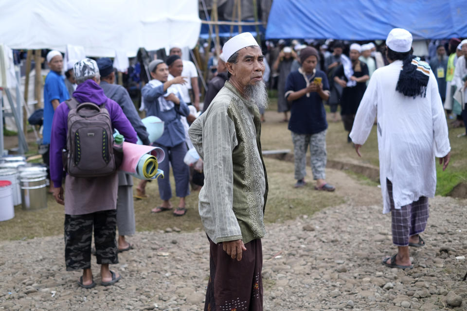 A Muslim pilgrim stands on a field where a mass congregation is supposed to be held in Gowa, South Sulawesi, Indonesia, Thursday, March 19, 2020. Indonesia halted the congregation of thousands of Muslim pilgrims and began quarantining and checking their health Thursday to prevent the spread of the new coronavirus. The vast majority of people recover from the new coronavirus. According to the World Health Organization, most people recover in about two to six weeks, depending on the severity of the illness. (AP Photo/Syaief)