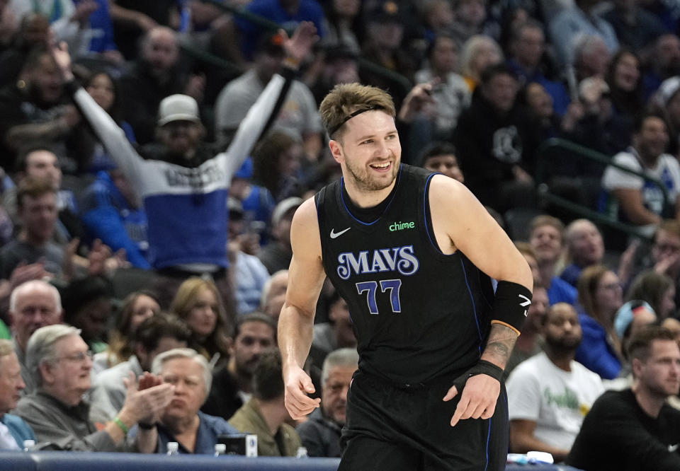 Dallas Mavericks guard Luka Doncic smiles after hitting a three pointer during the first half of an NBA basketball game against the Utah Jazz in Dallas, Wednesday, Dec. 6, 2023. (AP Photo/LM Otero)