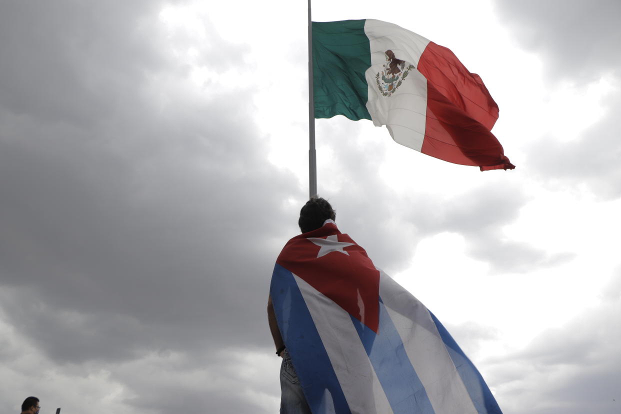 A person of cuban origin demonstrated carrying a Cuban flag on the flagpole of the Zócalo in Mexico City, against the current government of Miguel Díaz-Canel, president of Cuba, due to the lack of medicines and medical attention due to the increase of HIV/AIDS infections and in support of the demonstrations during the last days on the island. (Photo by Gerardo Vieyra/NurPhoto via Getty Images)