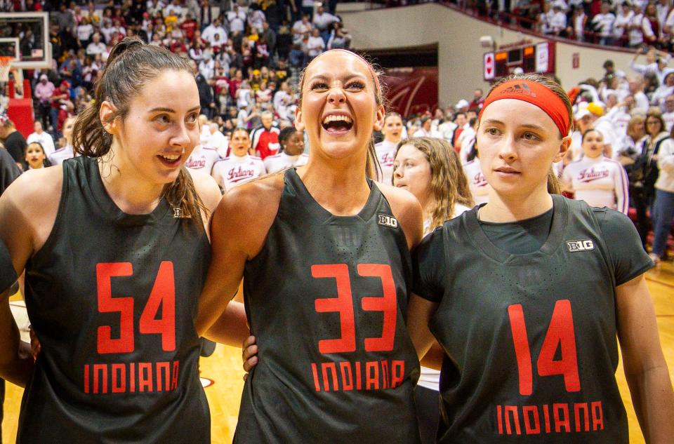 Indiana's Mackeznie Holmes (54), Sydney Parrish (33, and Sara Scalia (14) celebrate after the second half of the Indiana versus Iowa women's basketball game at Simon Skjodt Assembly Hall on Thursday, Feb. 22, 2024.