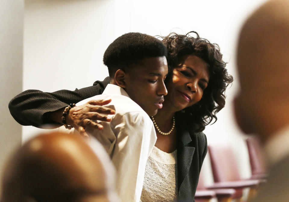 Dallas County District Attorney Faith Johnson hugs Kevon Edwards, the older brother of Jordan Edwards, during the trial of former Balch Springs police officer Roy Oliver, who is charged with the murder of 15-year-old Jordan Edwards, at the Frank Crowley Courts Building in Dallas on Monday, Aug. 27, 2018. (Rose Baca/The Dallas Morning News via AP, Pool)