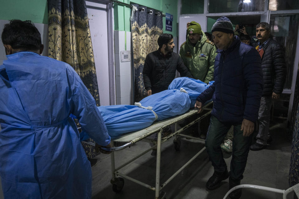 A paramedic and volunteers transport the body of a Russian skier in a hospital in Tangmarg, near Gulmarg, a popular skiing destination in Indian controlled Kashmir, Thursday, Feb. 22, 2024. Officials say that the Russian skier was killed by an avalanche that hit Gulmarg on Thursday. (AP Photo/Dar Yasin)