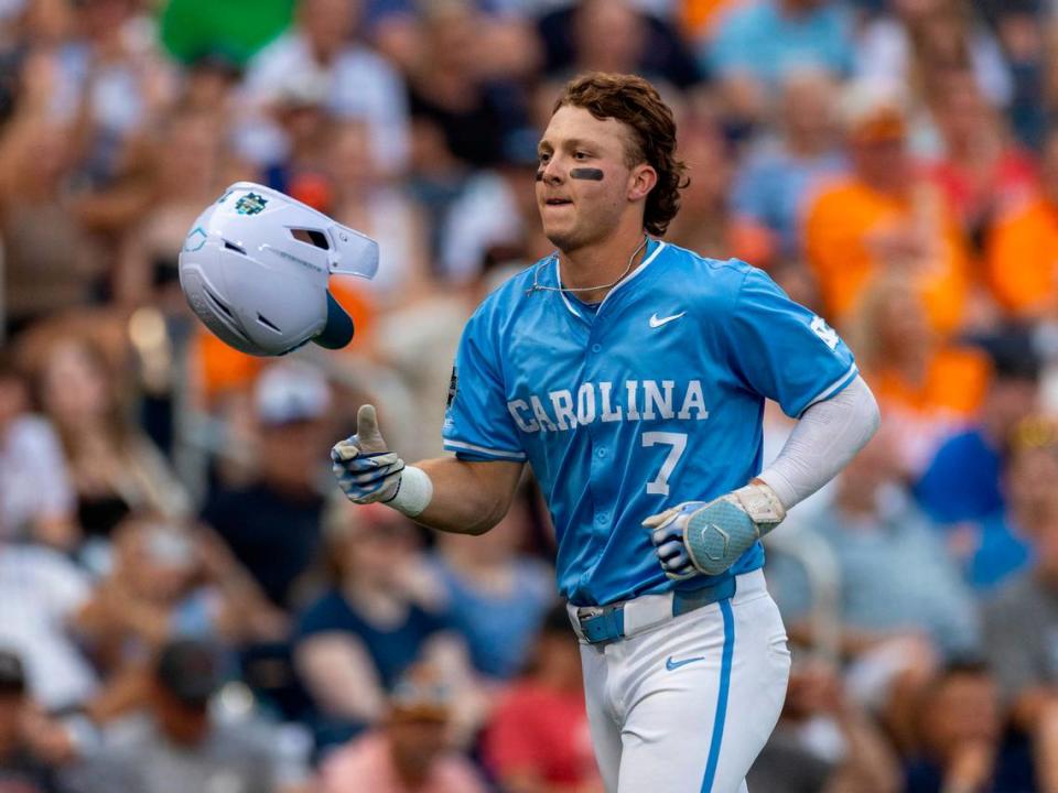 North Carolina outfielder Vance Honeycutt (7) flips his batting helmet after connecting for a home run in the sixth inning against Tennessee during the College World Series on Sunday, June 16, 2024 at Charles Swab Field in Omaha, Nebraska.