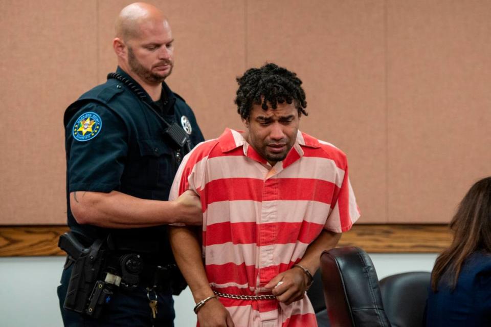 Denilson Marcus Elligson, 27, cries as he is escorted from the courtroom after a probable cause hearing at Harrison County Court in Gulfport on Tuesday, June 25, 2024. Elligson is accused of capital murder and child abuse in the death of his infant son.