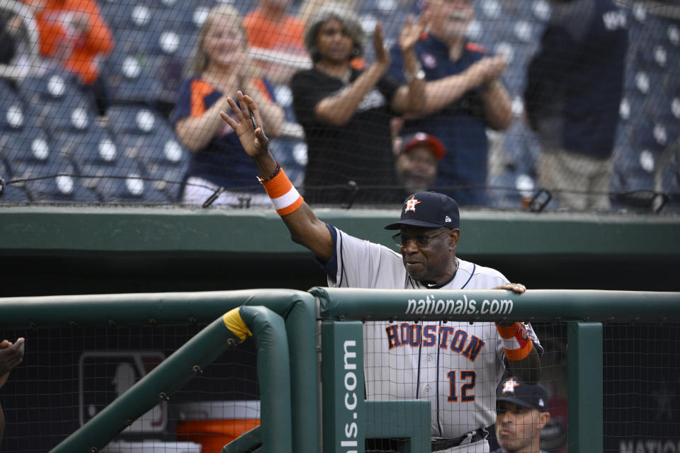 Houston Astros manager Dusty Baker Jr. (12) waves to the crowd as he is recognized before a baseball game against the Washington Nationals, Friday, May 13, 2022, in Washington. (AP Photo/Nick Wass)