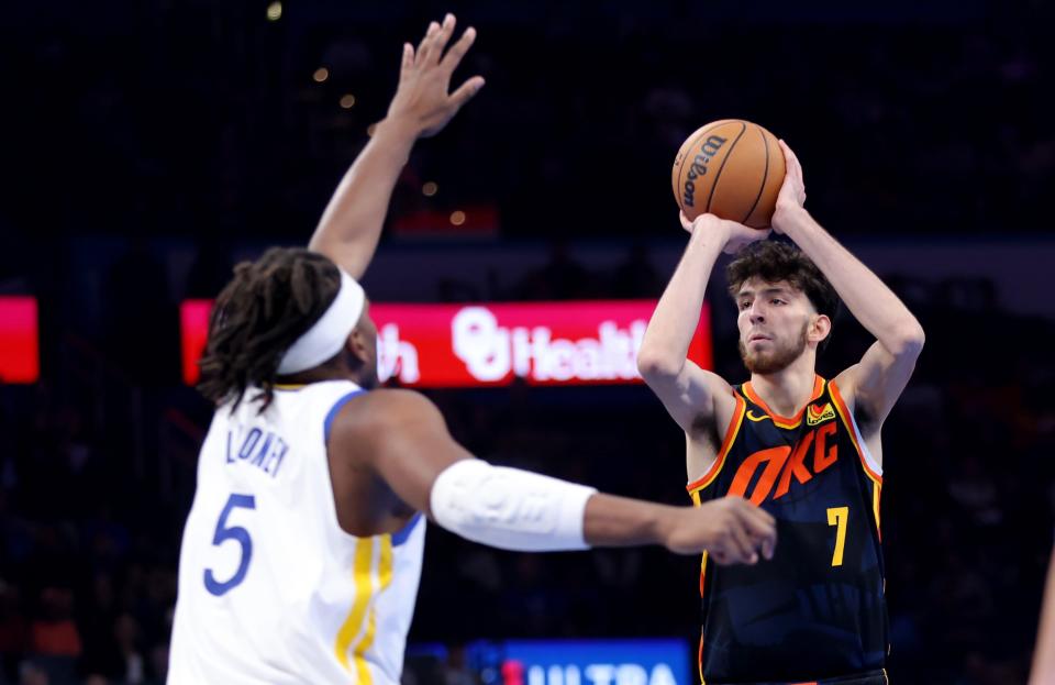 Oklahoma City Thunder forward Chet Holmgren (7) shoots as Golden State Warriors forward Kevon Looney (5) defends in the second half of the NBA basketball game between the Oklahoma City Thunder and the Golden State Warriors at Paycom Center in Oklahoma City, Friday, Nov., 3, 2023.