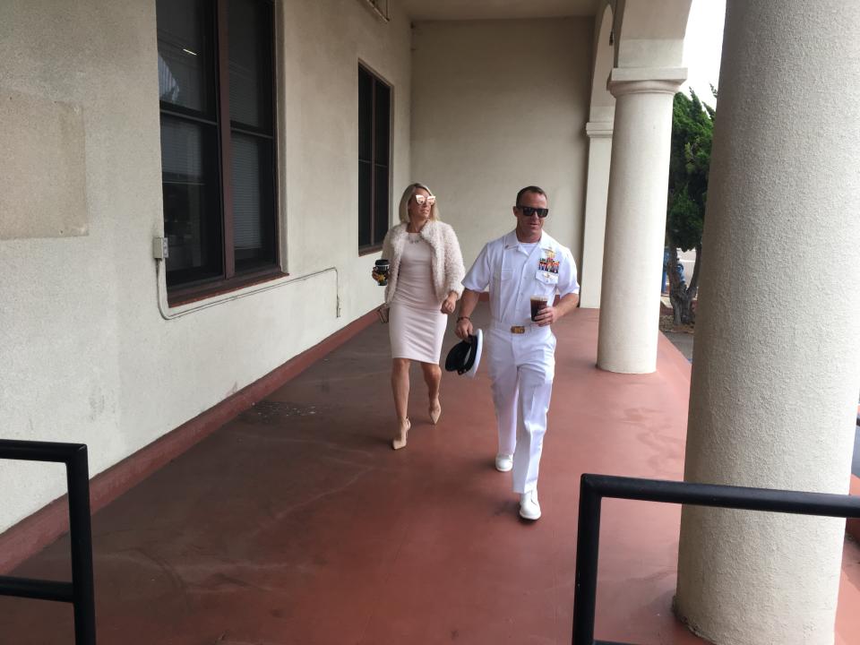 Navy Special Operations Chief Edward Gallagher, right, walks with his wife, Andrea Gallagher as they arrive to military court on Naval Base San Diego, Monday, June 24, 2019, in San Diego. Trial continues in the court-martial of the decorated Navy SEAL, who is accused of stabbing to death a wounded teenage Islamic State prisoner and wounding two civilians in Iraq in 2017. He has pleaded not guilty to murder and attempted murder, charges that carry a potential life sentence. (AP Photo/Julie Watson)