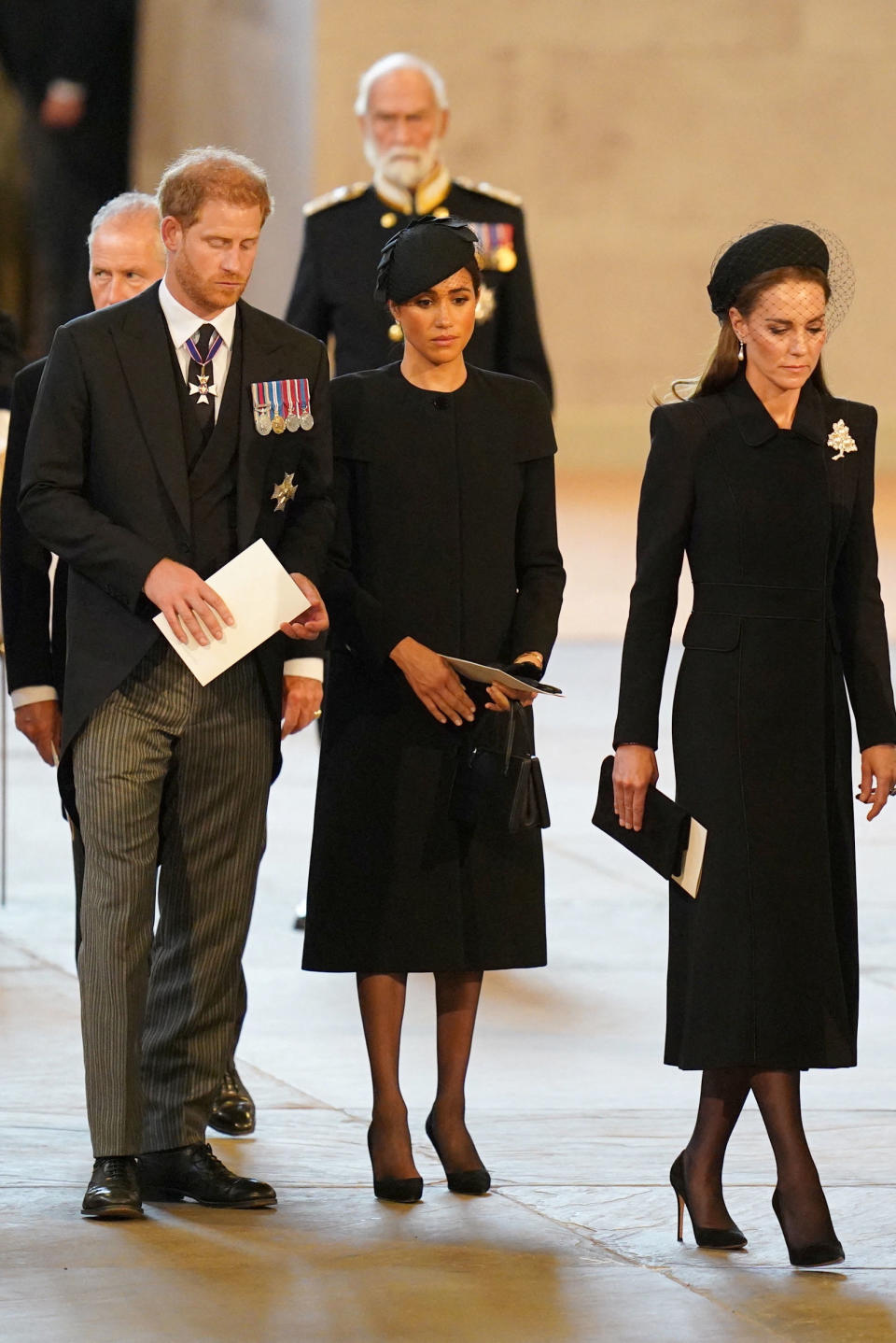 <p>Britain's Catherine, Princess of Wales, Prince Harry and Meghan, Duchess of Sussex follow the bearer party carrying the coffin of Queen Elizabeth II into Westminster Hall, London, where it will lie in state ahead of her funeral on Monday. September 14, 2022. Jacob King/Pool via REUTERS</p> 