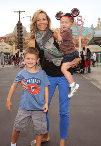 <p>Paul Hiffmeyer/Disneyland Resort via Getty</p> Sheryl Crow with sons Wyatt and Levi in 2012.