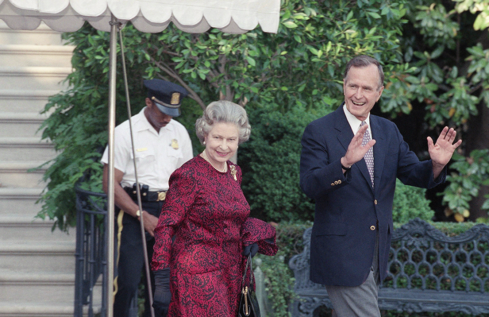 President George H.W. Bush escorts the Queen from the White House to a helicopter en route to Baltimore to watch her first major league baseball game in Washington in 1991 (AP)