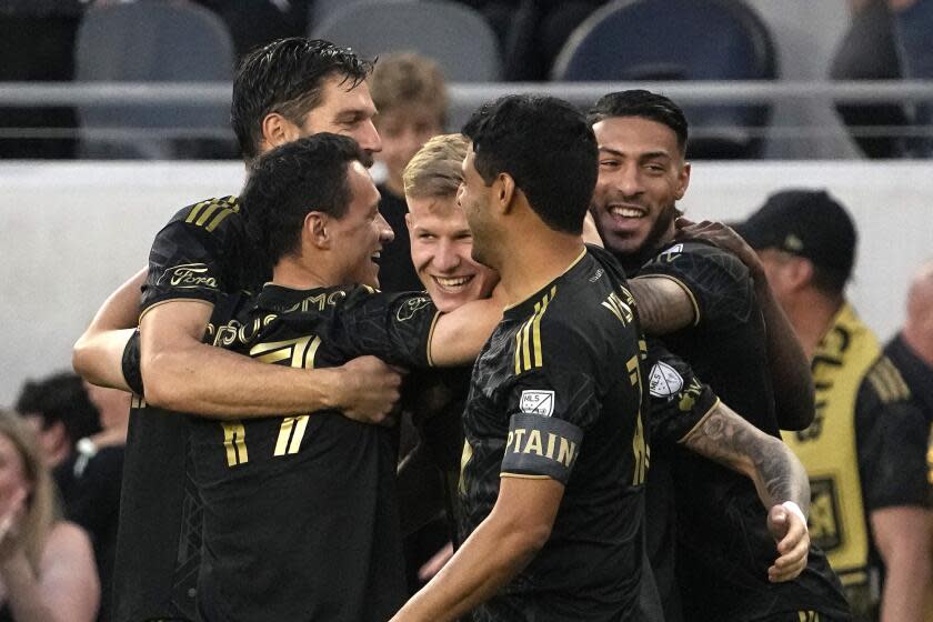 Los Angeles FC midfielder Mateusz Bogusz, center, celebrates his goal with teammates during the first half of a Major League Soccer match against the Seattle Sounders Wednesday, June 21, 2023, in Los Angeles. (AP Photo/Mark J. Terrill)