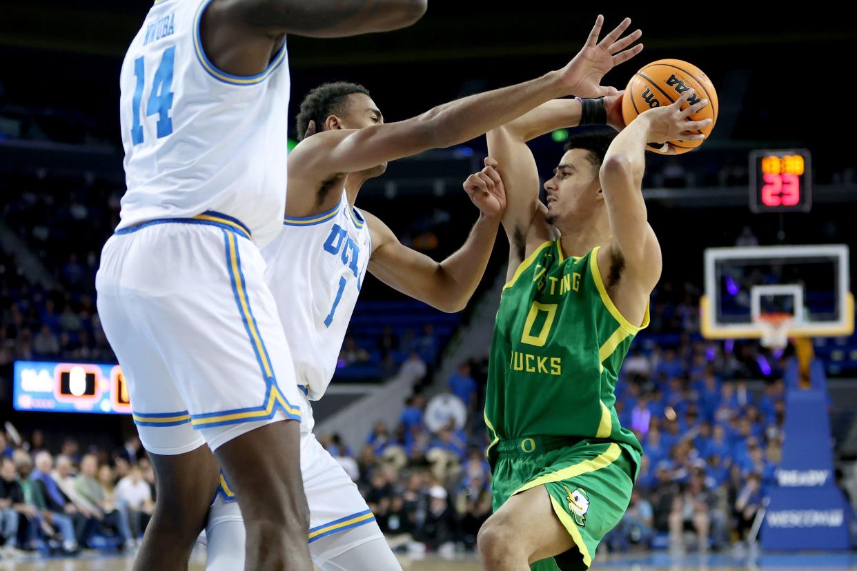 UCLA Bruins guard Abramo Canka (1) defends Oregon Ducks guard Will Richardson (0) during the first half at Pauley Pavilion on Sunday.