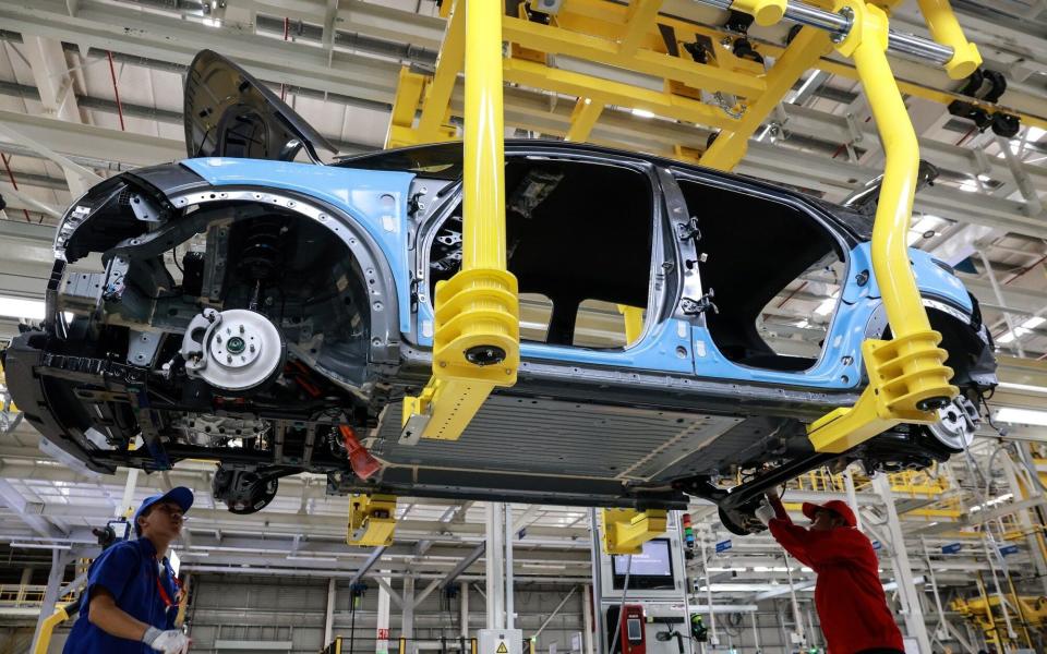 Workers assemble a BYD Co. Dolphin compact hatchback electric vehicle