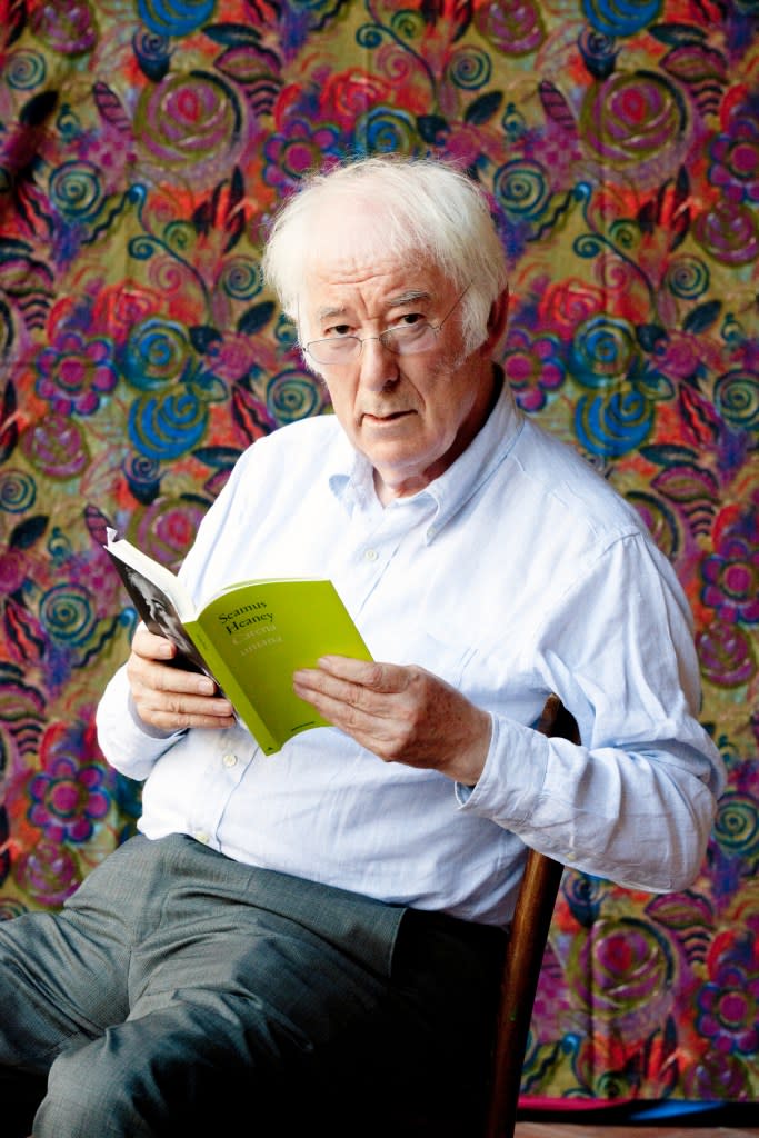 Poet Seamus Heaney reading a book. Getty Images