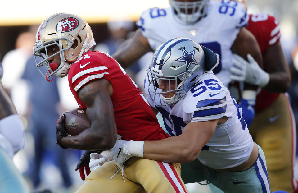 San Francisco 49ers running back Raheem Mostert, left, tries to get away from Dallas Cowboys linebacker Leighton Vander Esch (55) during the first half of an NFL preseason football game in Santa Clara, Calif., Saturday, Aug. 10, 2019. (AP Photo/John Hefti)