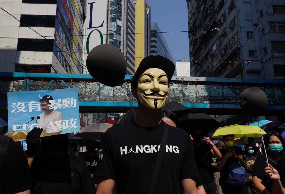 Anti-government protesters wearing masks march in Hong Kong, Oct. 1, 2019. (Photo: Vincent Yu/AP)