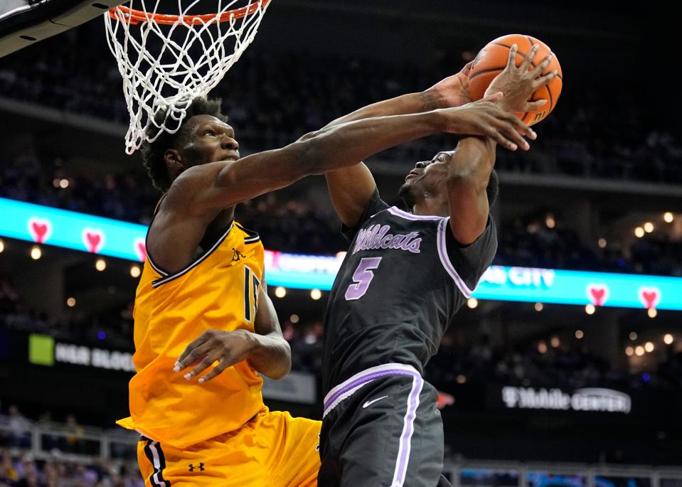 Dec 21, 2023; Kansas City, Missouri, USA; Kansas State Wildcats guard Cam Carter (5) shoots against Wichita State Shockers center Quincy Ballard (15) during the first half at T-Mobile Center. Mandatory Credit: Jay Biggerstaff-USA TODAY Sports