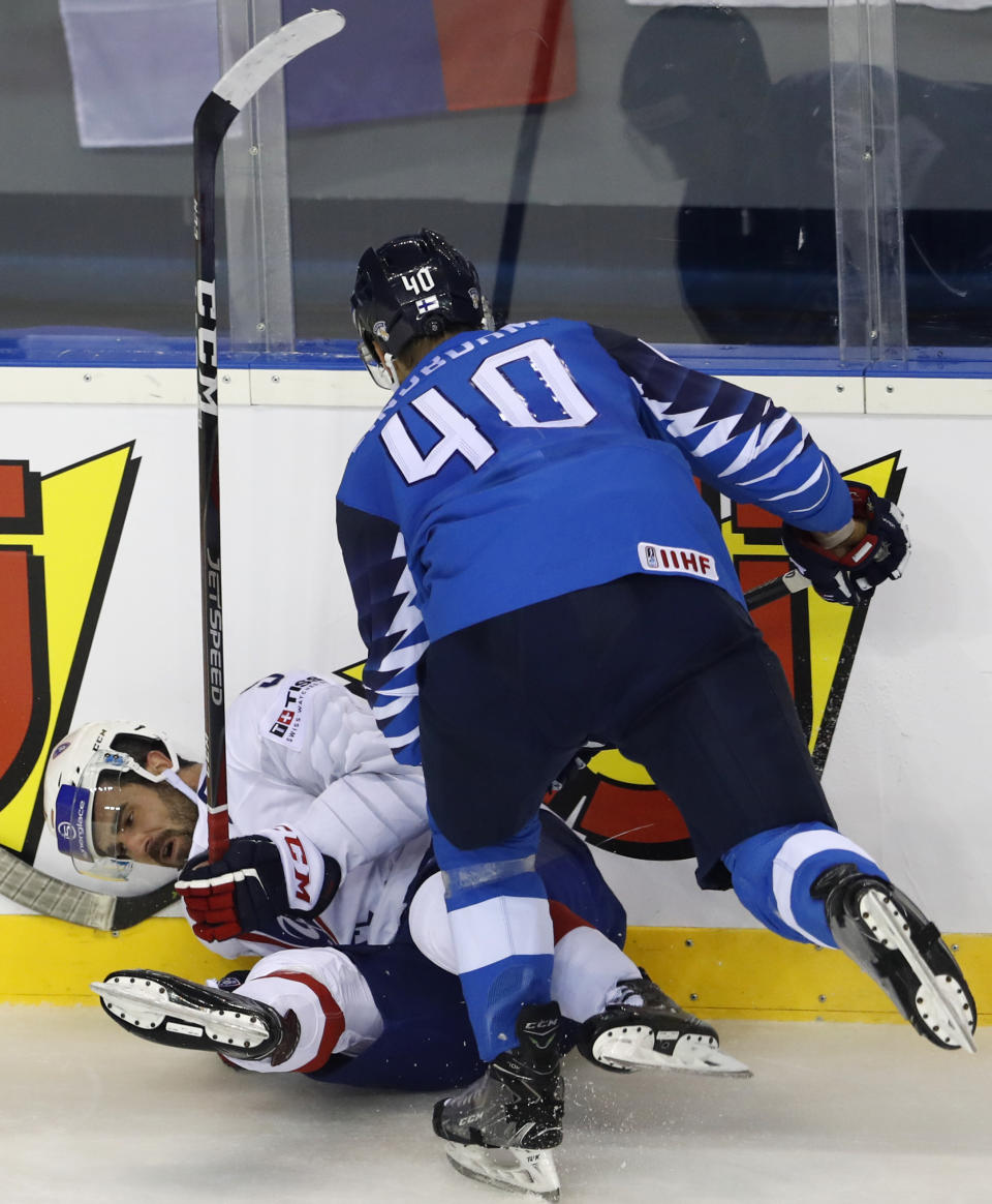 Finland's Petteri Lindbohm, right, checks Damien Fleury of France, left, during the Ice Hockey World Championships group A match between France and Finland at the Steel Arena in Kosice, Slovakia, Sunday, May 19, 2019. (AP Photo/Petr David Josek)