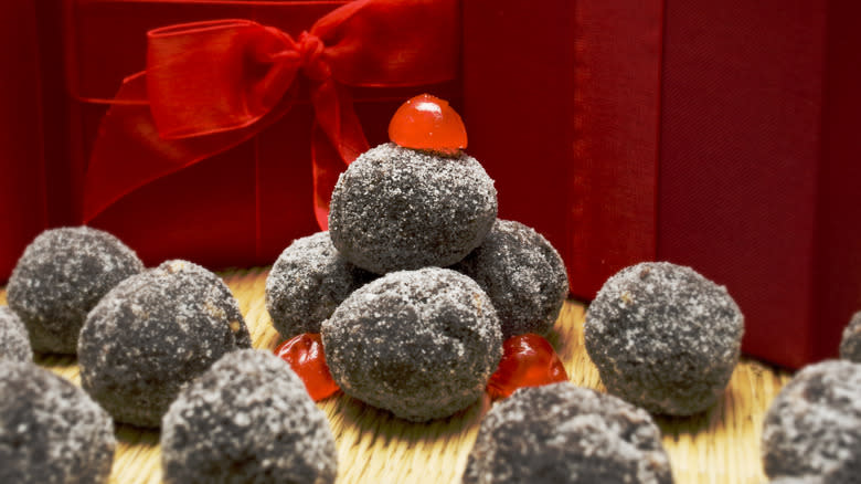chocolate bourbon balls in front of gift ribbon