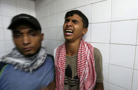 A relative of Palestinian Mohammad Al-Hamayda, who was killed by Israeli forces during a protest at the Israel-Gaza border, reacts at a hospital in the southern Gaza Strip June 29, 2018. REUTERS/Ibraheem Abu Mustafa